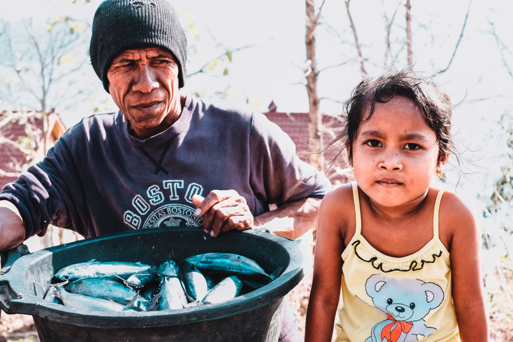 Bali, Indonesia, fisherman, daughter, fish in a bucket, 